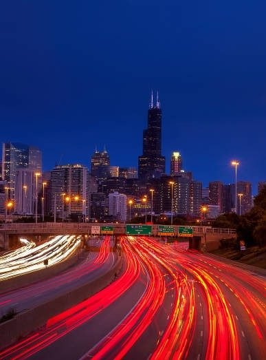Light trails on the expressway below the Chicago skyline at night